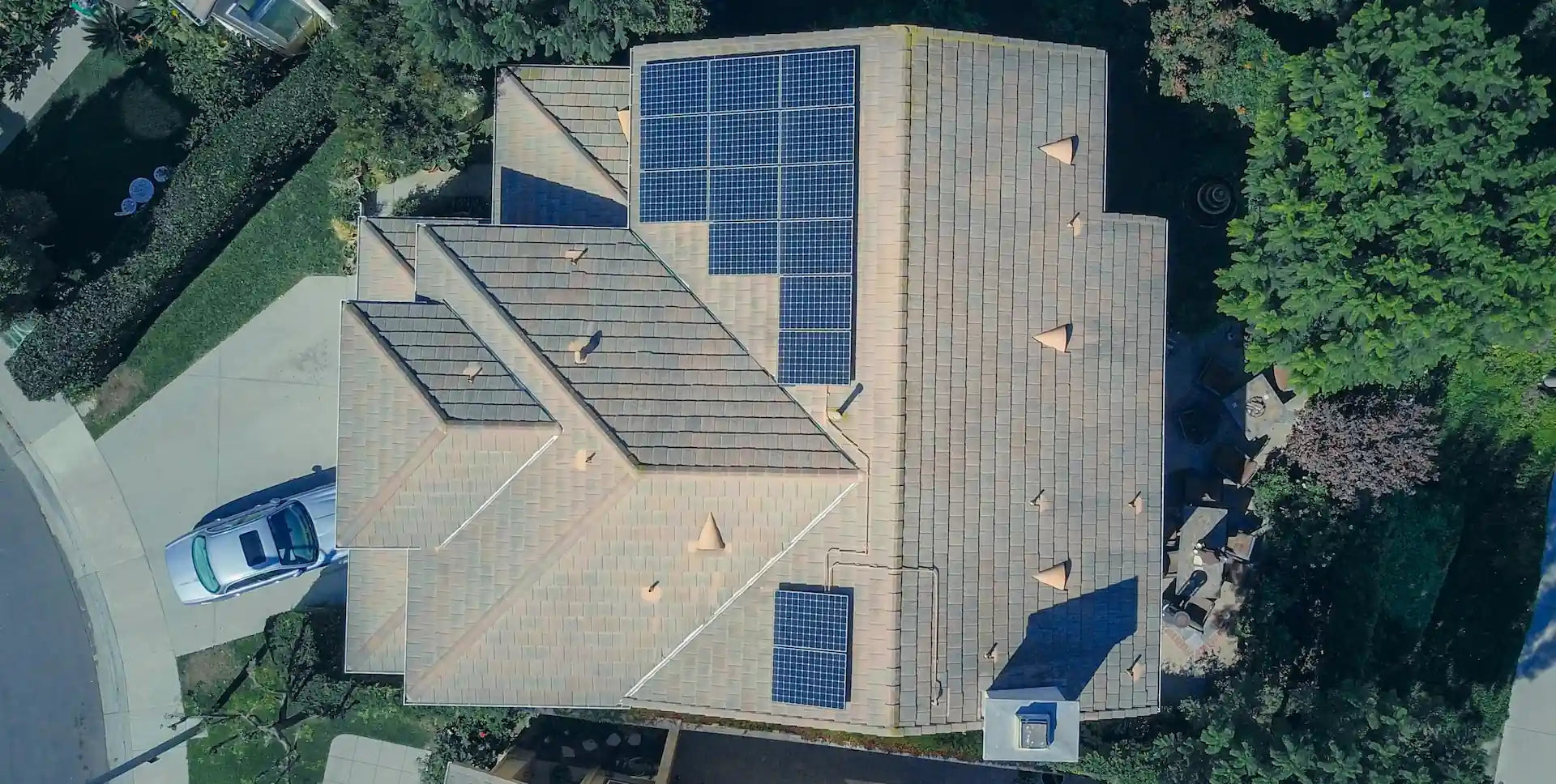 Aerial photo looking down on a house with solar panels divided into zones on different parts of the roof